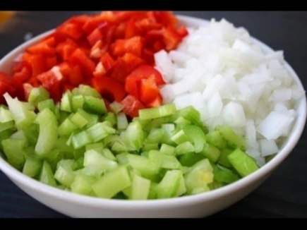 This photo is of a bowl of onions, celery, and bell peppers.